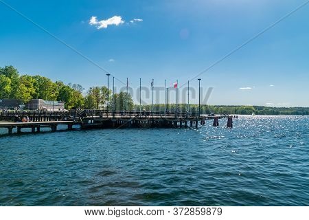 Olsztyn, Poland - May 31, 2020: Wooden Pier With Polish Flags On The City Beach On Ukiel Lake.