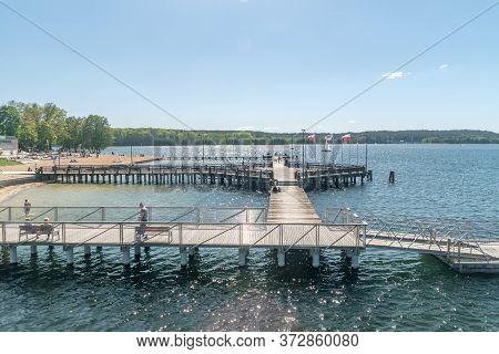 Olsztyn, Poland - May 31, 2020: View On Wooden Pier On Ukiel Lake At Sunny Day.