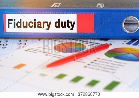 On The Table Are Pie Charts, A Pen And A Folder With The Inscription - Fiduciary Duty. Business And 