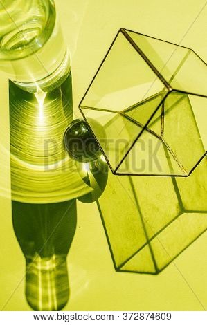 Tiny Glass Cube, Water Bottle, Steel Sphere And Their Disproportionate Shadows