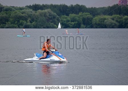 Moscow, Russia - June 2020: Rescuer In Life Vest Rides A Water Scooter On The Moscow River. Safety O