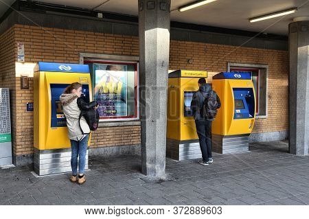 Eindhoven, Netherlands - November 19, 2016: Passengers Buy Tickets With Chip Card At Railway Station