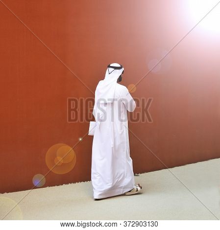 An Elegant Man Of Arab Ethnicity With Sunglasses Walks The Streets Of His Country