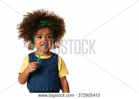 A Little Cute African American Girl Brushing Her Teeth, Isolated Over White Background With Copyspac