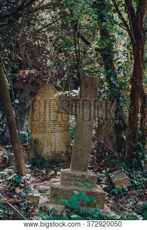 London, Uk - June 16, 2020: Cross Amongst Tombstones Inside Hampstead Cemetery, A Historic Cemetery 