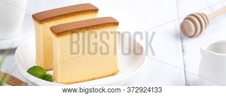 Castella (kasutera) - Beautiful Delicious Japanese Sliced Sponge Cake Food On White Plate Over Rusti