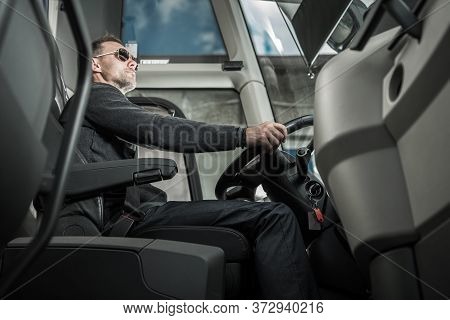 Public Transportation Theme. Caucasian International Coach Bus Driver In His 40s Preparing For Trave