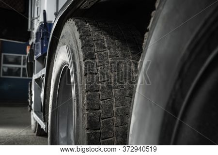 Heavy Duty Transportation Safety. Semi Truck Used Tire Tread Close Up. Transportation Theme.
