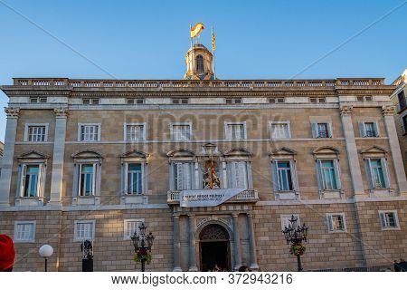 Barcelona, Spain - December 19, 2018: People Walk In Front Of The Generalitat Palace Of Catalonia In