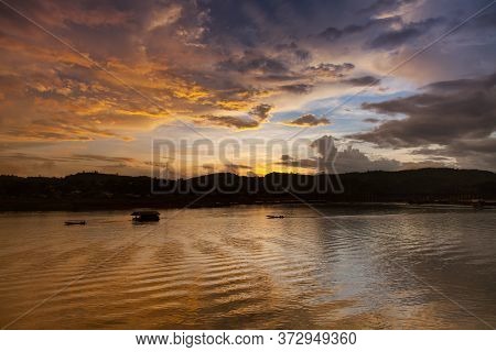A Colorful Sky At Twilight Of Sunset Is Reflecting On Water In Dam Located At Kanchanabure Province 