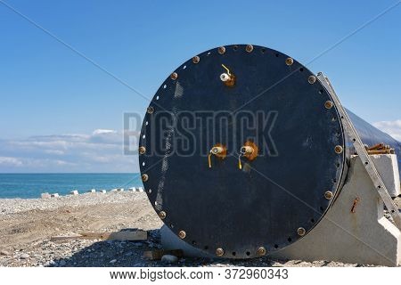 A Locked Large Plastic Pipeline On The Coast With Blue Sea And Sky Background