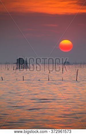 Beautiful Landscape View Of Sunset Time Going Down To In The Sea With Foreground Of Beach In Tropica