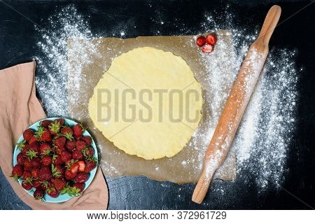 Homemade Strawberry Galette With Fresh Ripe Strawberries On A Dark Background, Top View. Ingredients