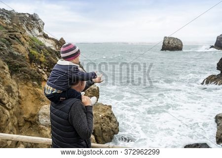 Father And Little Son Admiring Nature In Peniche, Portugal