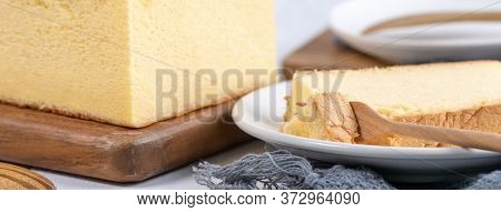 Plain Classic Taiwanese Traditional Sponge Cake (taiwanese Castella Kasutera) On A Wooden Tray Backg