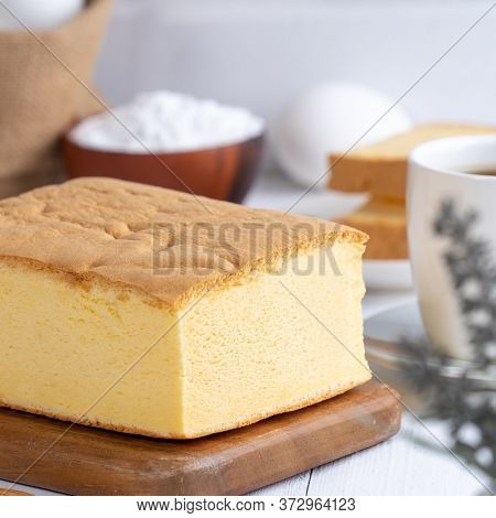 Plain Classic Taiwanese Traditional Sponge Cake (taiwanese Castella Kasutera) On A Wooden Tray Backg