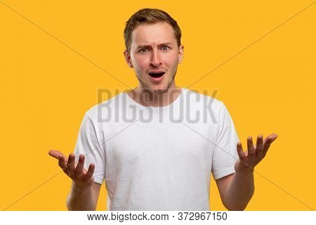 Wtf Portrait. Failure Loss. Overwhelmed Shocked Man With Open Mouth Raising Hands Isolated On Orange