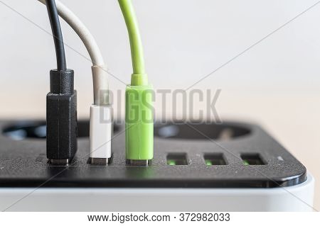 Modern Convenient Multi-port Usb Charger For Devices. Close-up Of Multi-colored Cables In A Power Ou