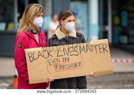 Richmond, North Yorkshire, Uk - June 14, 2020: White Female Protesters Hold A Homemade Black Lives M