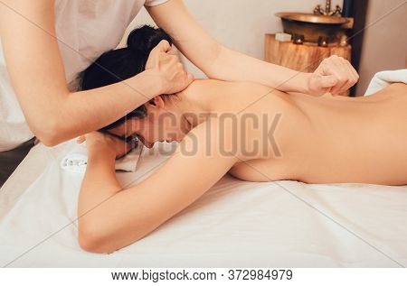 Beautiful Brunette Enjoying A Sabay Massage In An Oriental Spa Salon. Sabai Massage Is A Combination