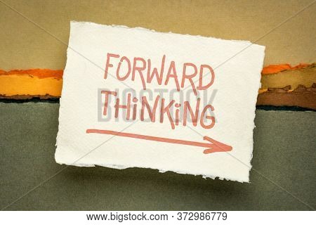 forward thinking- inspirational handwriting on a handmade rag paper against abstract landscape, business, education and personal development concept