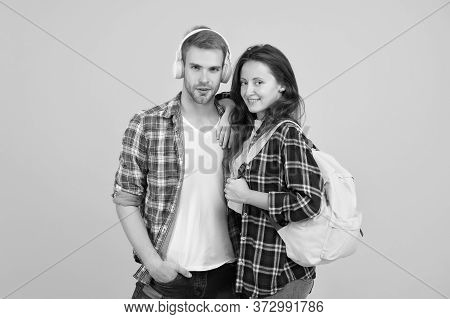 Youth Lead Way In Fashion Ideas. Hipster Couple Students. Fashionable Students Couple Yellow Backgro