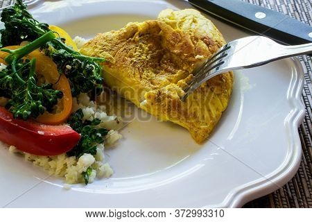 Closeup And Selective Focus On Paleo Dish Of Cauliflower Rice Stir-fry On White Plate, On Bamboo Pla