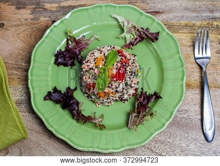 Closeup On Green Plate With Tri-color Quinoa Salad On Wooden Table, And A Fork - Quinoa Is A Pseudog