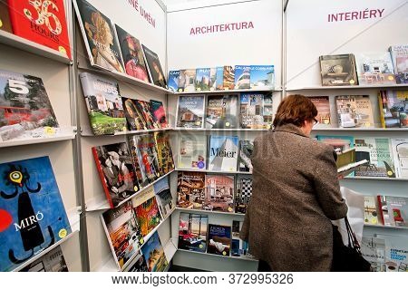 Prague, Czechia: Customer Reading And Buying A Book Of The Publishing House Taschen In A Bookstore O