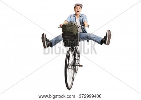 Happy guy riding a bicycle and spreading legs isolated on white background