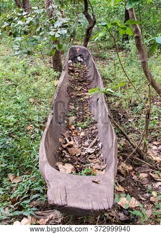 A Long, Abandoned Dugout Canoe In The Woods Of Mozambique