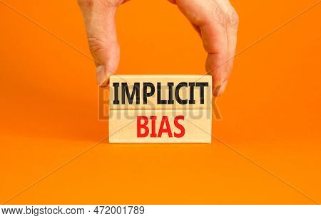 Implicit Bias Symbol. Concept Words Implicit Bias On Wooden Block. Beautiful Orange Table Orange Bac