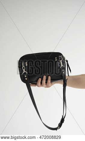 Leather Black Handmade Bag Over His Shoulder. Dark Designer Banana Bagon A White Background. Comfort