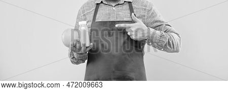 Man Crop View In Apron Pointing Finger At Orange And Juice Bottle Yellow Background, Juicery