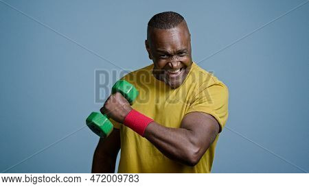 Mature Strong Athletic Man Coach Pumping Biceps With Dumbbell In Studio On Gray Background Doing Exe