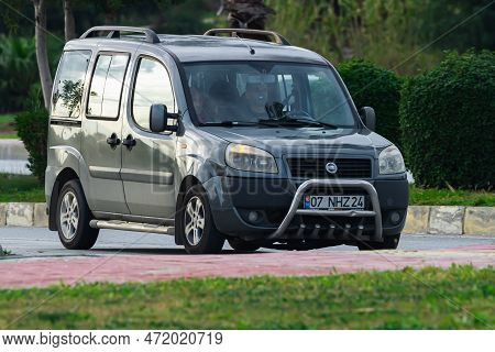 Side, Turkey -february  10, 2023:    Gray Fiat Doblo  Is Driving Fast On The Street On A Warm Summer