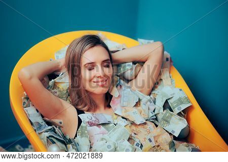 Rich Carefree Woman Bathing In A Tub Of Money