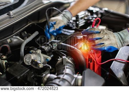 Transportation Repair Service Concept, Repairman Auto Mechanic Checking Battery Power Of Car After H