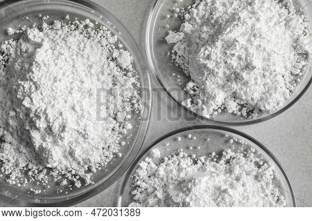 Petri Dishes With Calcium Carbonate Powder On Light Grey Table, Flat Lay