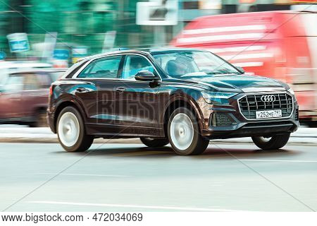 Audi Q8 Car Driving In City With Motion Blur, Front Side View. Brown Suv In Fast Motion On Street. M