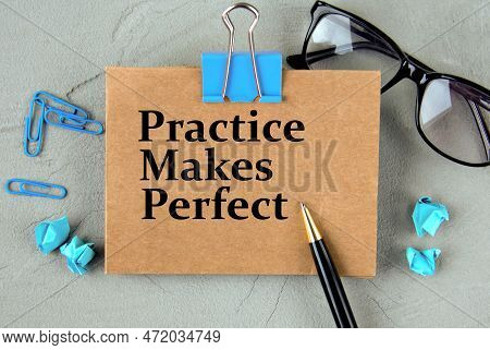 Practice Makes Perfect - Words On Brown Paper On The Background Of Glasses, Pens And Paper Clips. Bu
