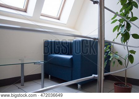 A Sitting Area In The Office Center, An Armchair And A Glass Table