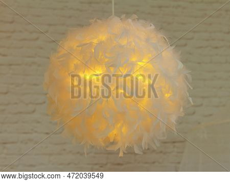 Modern Lamp With Abajur Made Of White Feathers, Gives Romantic Light In Bedroom
