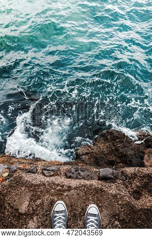 Suicidal Ideation Or Thoughts, Young Person Standing At The Ocean Cliff Above The Cold Water And Sea