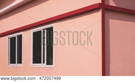 Sunlight And Shadow On Surface Of Glass Sliding Windows On Orange Concrete Wall With Red Edge Of Mod