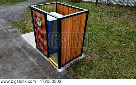 Closing Cage For Placing Chemical Toilets. Unsightly Plastic Boxes Are Inside Metal House With Flat 