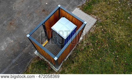 Closing Cage For Placing Chemical Toilets. Unsightly Plastic Boxes Are Inside Metal House With Flat 