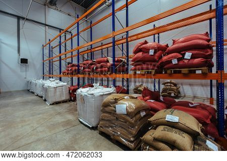 Bags With Production On Shelves In Warehouse. Bags With Coffee Beans Or Sugar Or Other