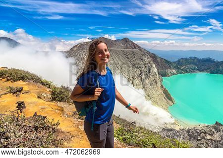 Woman Traveler At Crater Of Active Volcano Ijen, Java Island, Indonesia