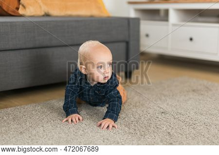 Nursery Baby Boy Crawling On Floor Indoors At Home Copy Space And Empty Space For Text - Baby Curios